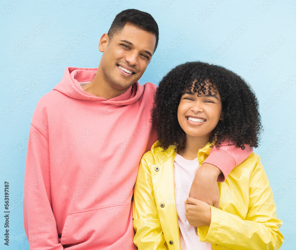 Happy couple, smile portrait and cool fashion standing in blue background for love, support and care