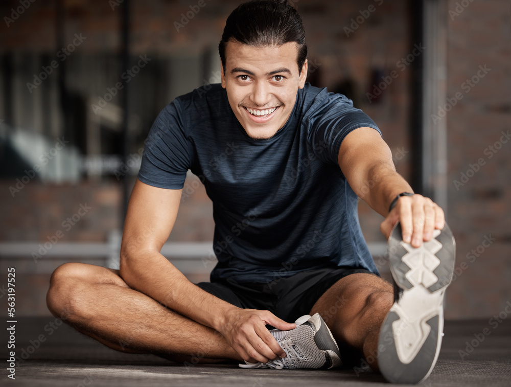 Portrait, fitness and stretching with a man athlete in gym getting ready for his workout routine. Ex