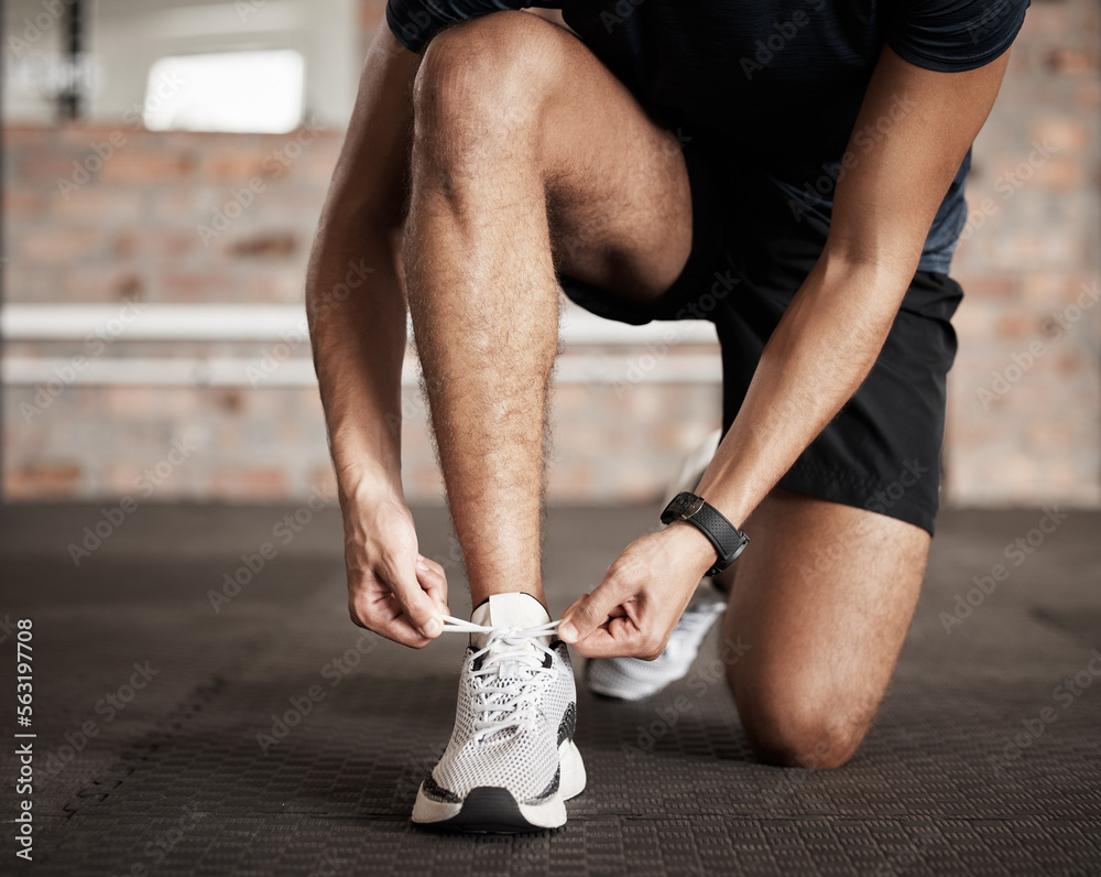 Fitness, man and tying shoe lace getting ready for running exercise, workout or training at gym. Spo