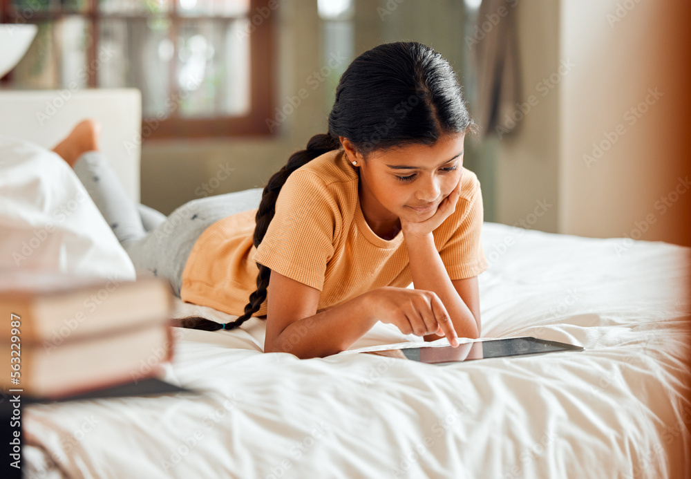 Little girl, tablet and smile on bed for elearning, education or learning while relaxing at home. Ha