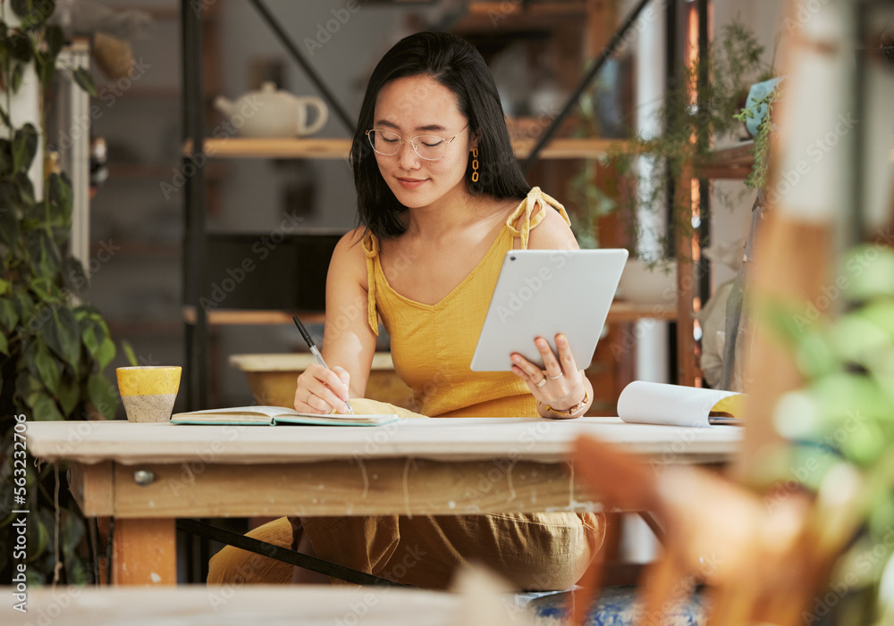 Thinking, research and tablet with asian woman writing in notebook in startup for management, planni