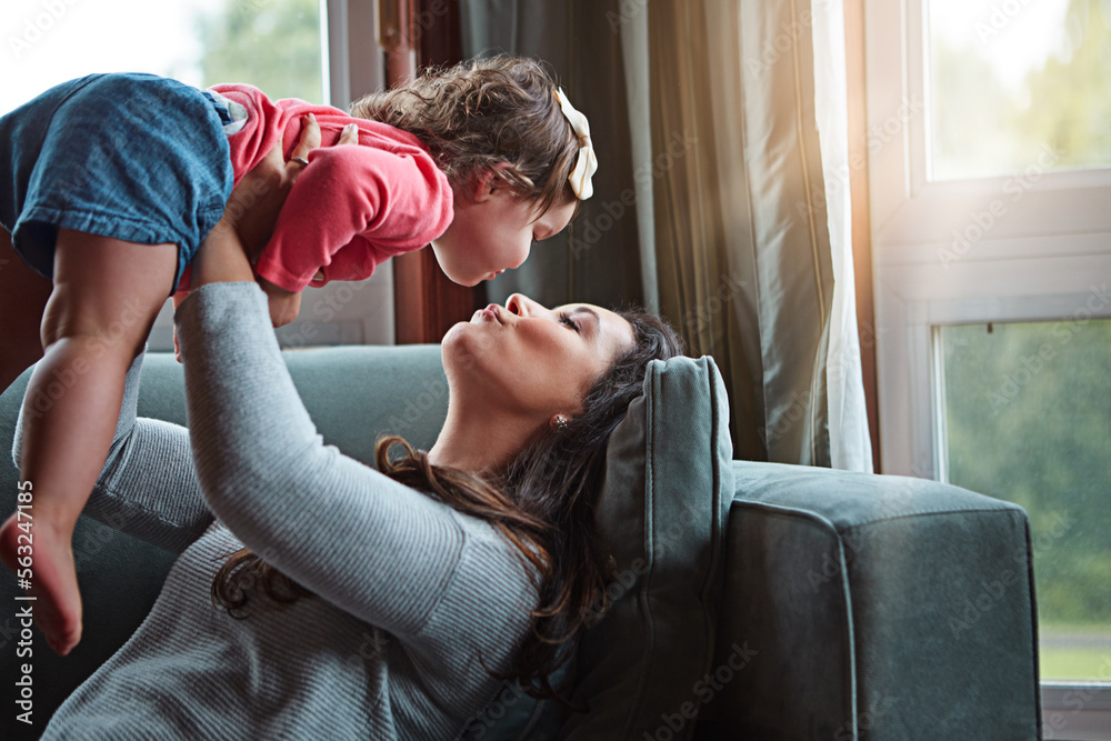 Relax, happy and kiss with mother and baby on sofa for bonding, quality time and child development. 