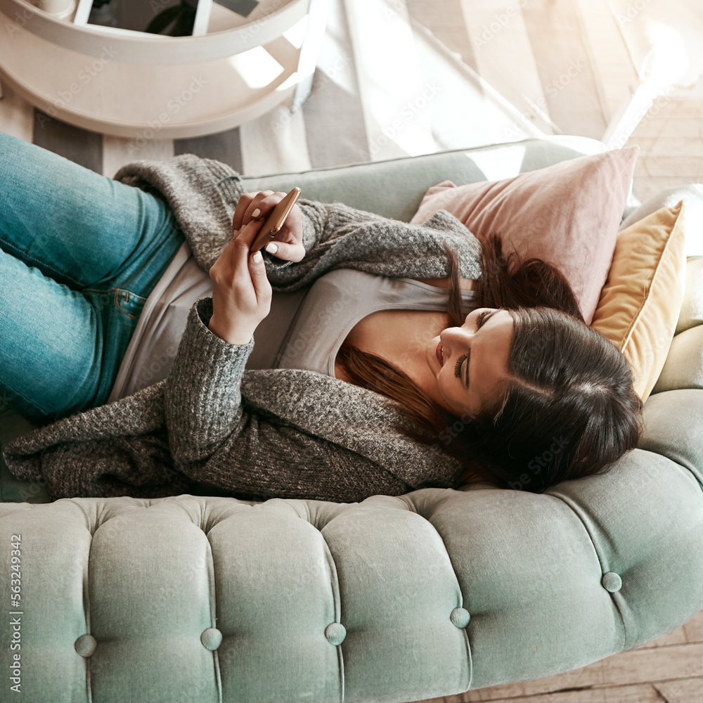 Social media, chat and above of woman on a phone for communication, app and contact on the sofa. Sea