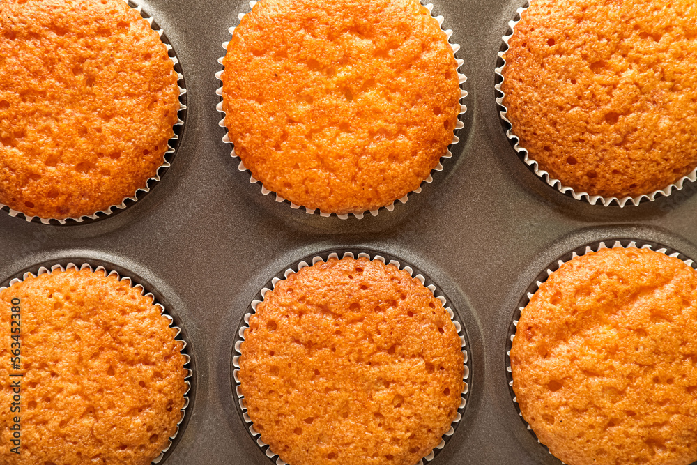 Baking tray with tasty muffins, closeup