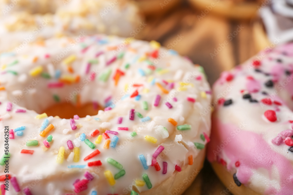 Sweet glazed donuts with sprinkles, closeup