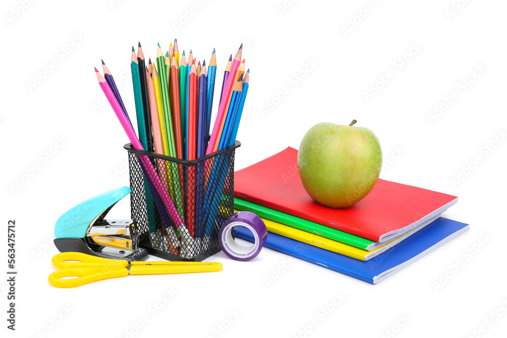 Green apple with notebooks, pencils holder and school stationery on white background