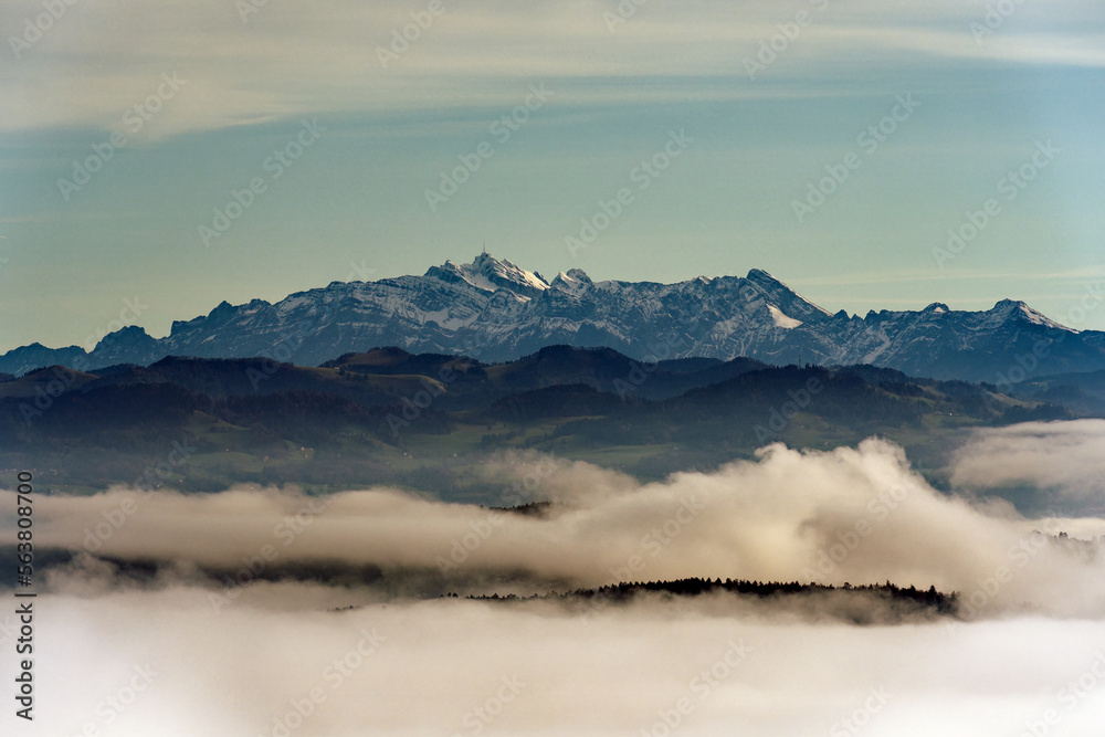 Aerial view from local mountain Uetliberg on a foggy winter day with Alpstein and Säntis peak and se