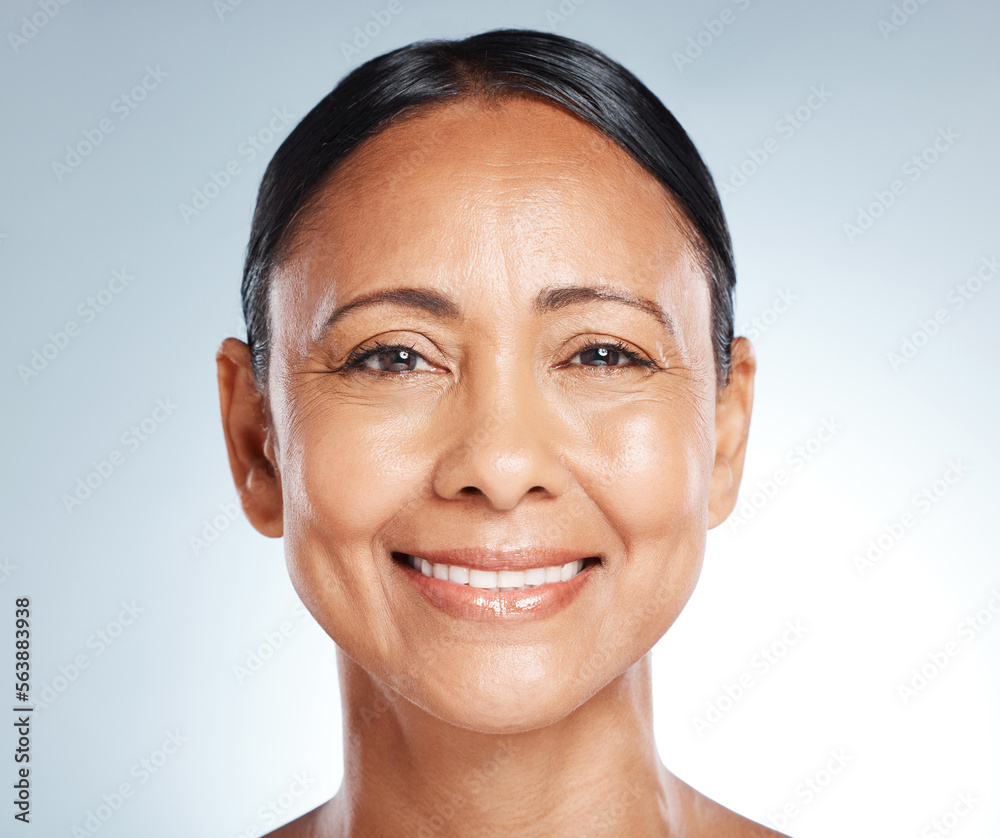 Smile, skincare and portrait of a senior woman with beauty isolated on a blue background in studio. 