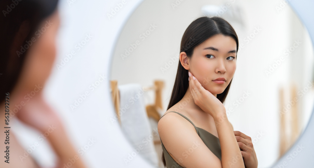 woman looking at mirror