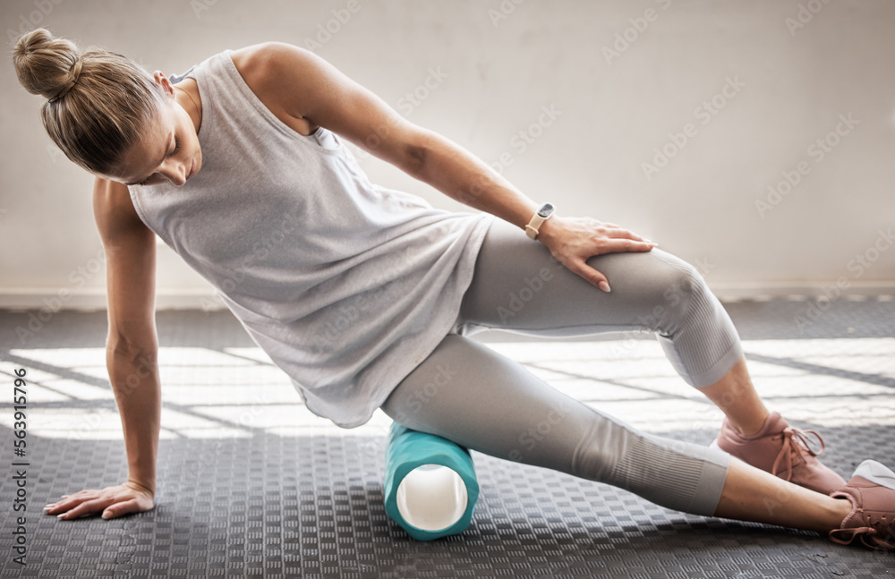 Fitness, physio massage and woman with roller on floor for leg tension and support in yoga workout a