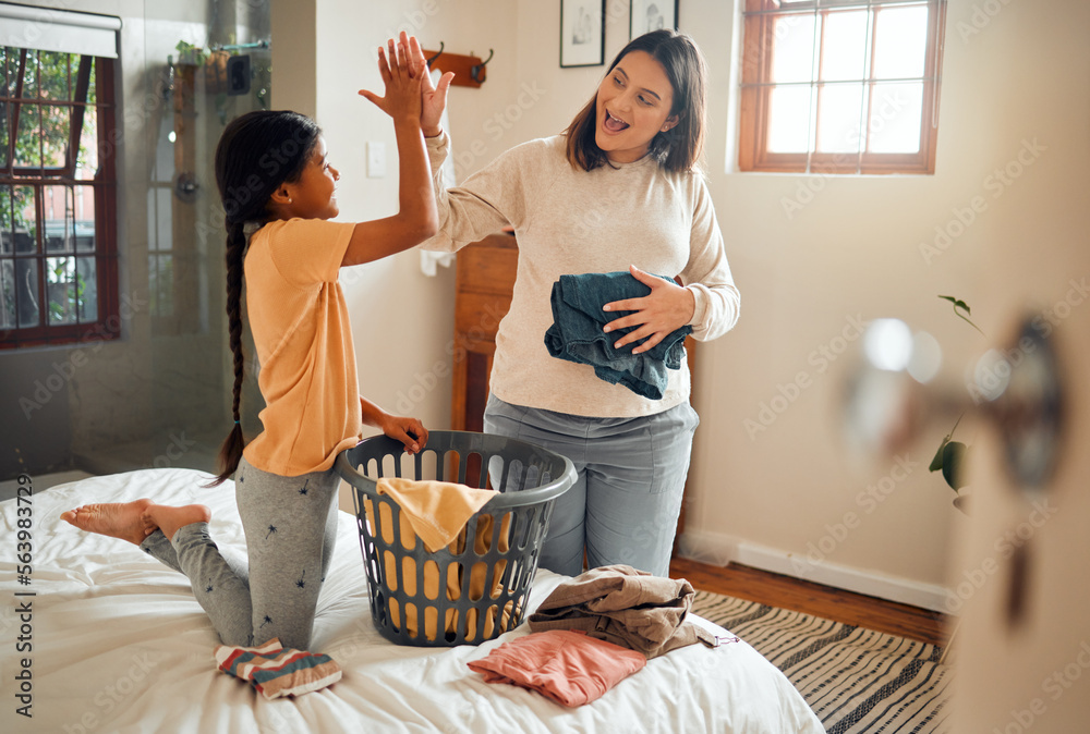 Cleaning, high five and child and mother doing laundry clothes, house work and fold clean fabric. Lo