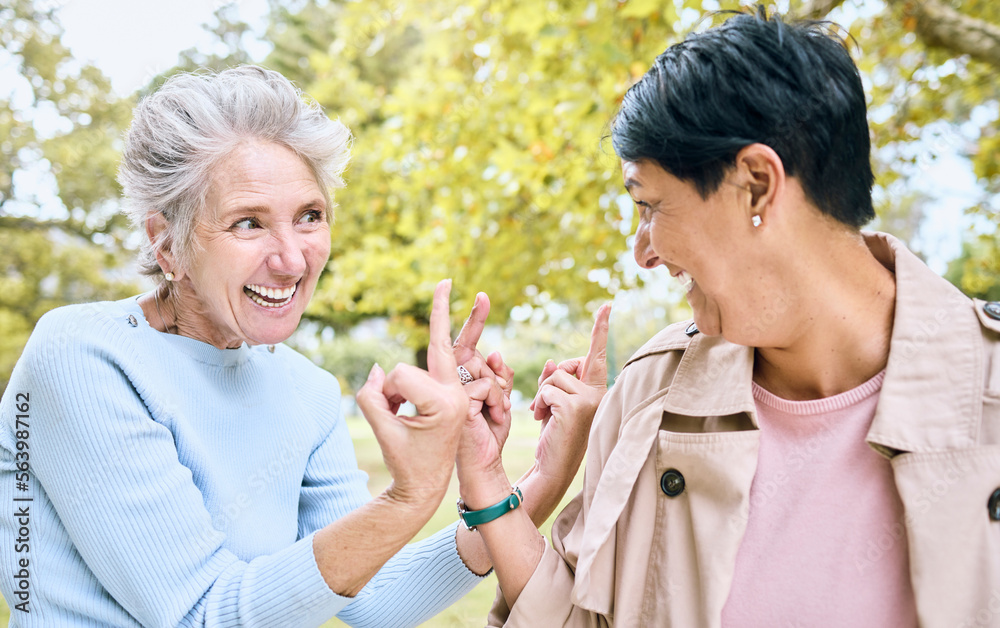 Elderly, women and middle finger at the park for fun, humor and silly while laughing together. Matur