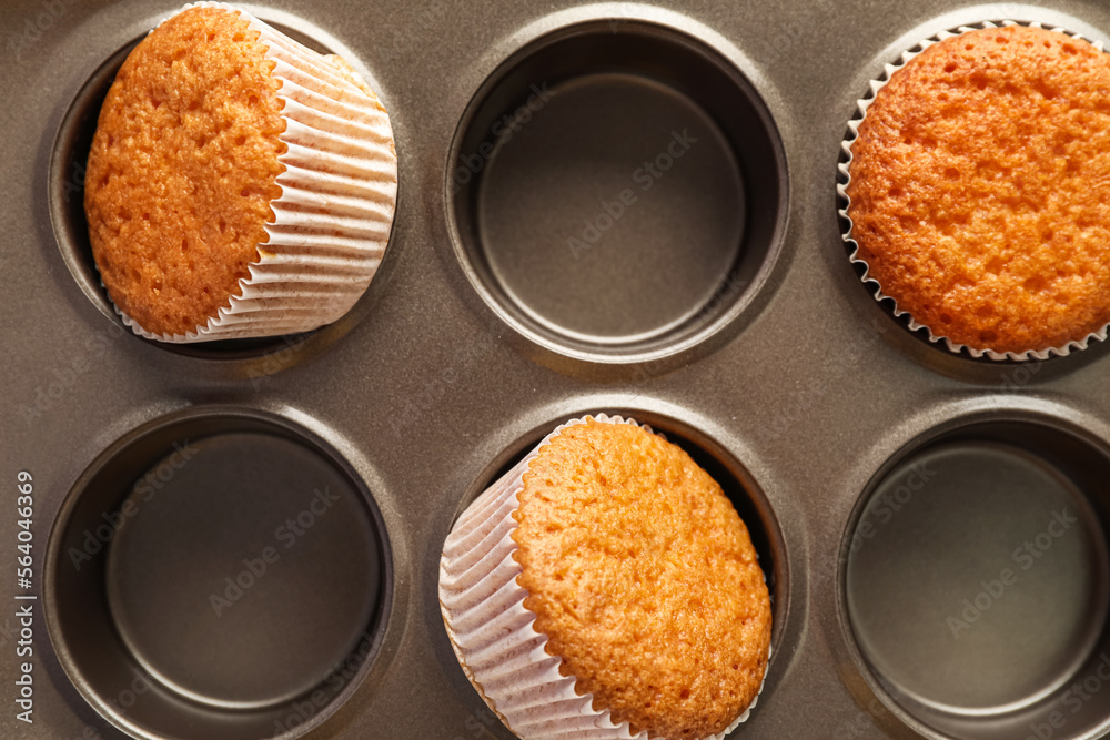 Baking tray with tasty muffins, closeup