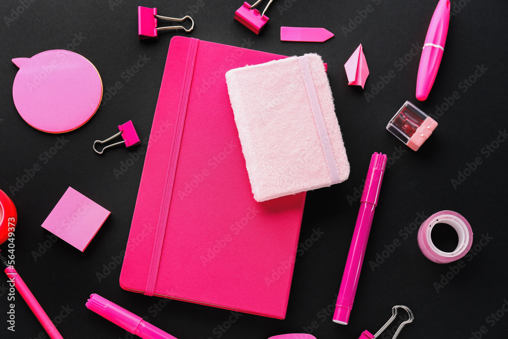 Set of colorful stationery with notebooks on dark background