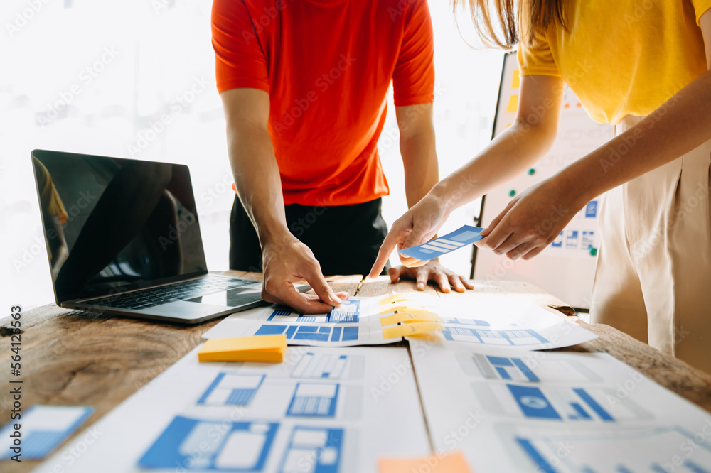  UX developer and ui designer brainstorming about mobile app interface wireframe design with custome