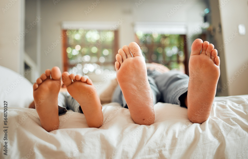 Feet, family and dad sleeping on a bed with child in a bedroom at a home or house bonding together. 