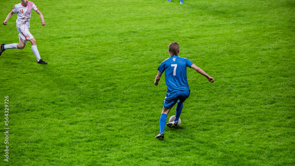 Professional Soccer Football Match Championship: Blue Team Players Attacks, White Player Tries to Ta