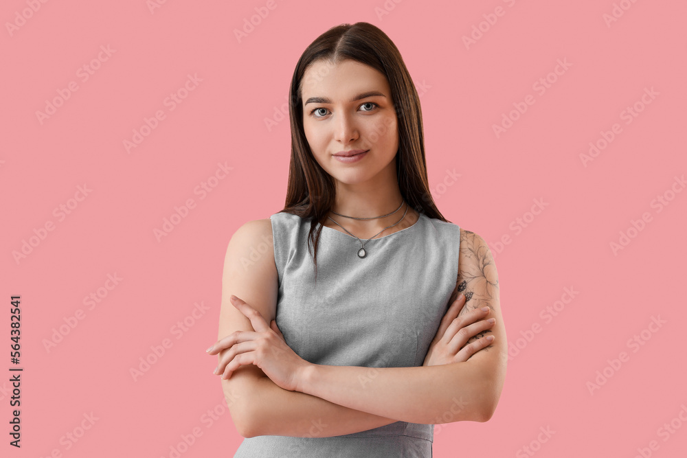 Young woman with stylish necklace on pink background