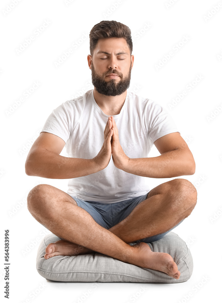 Handsome bearded man meditating on white background