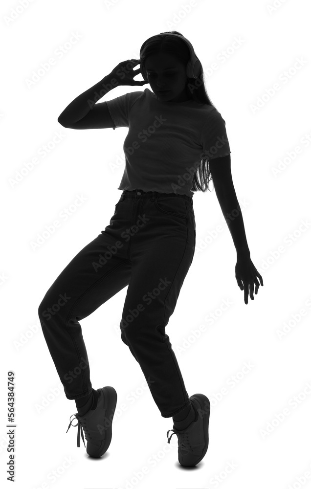 Silhouette of young woman in headphones dancing on white background