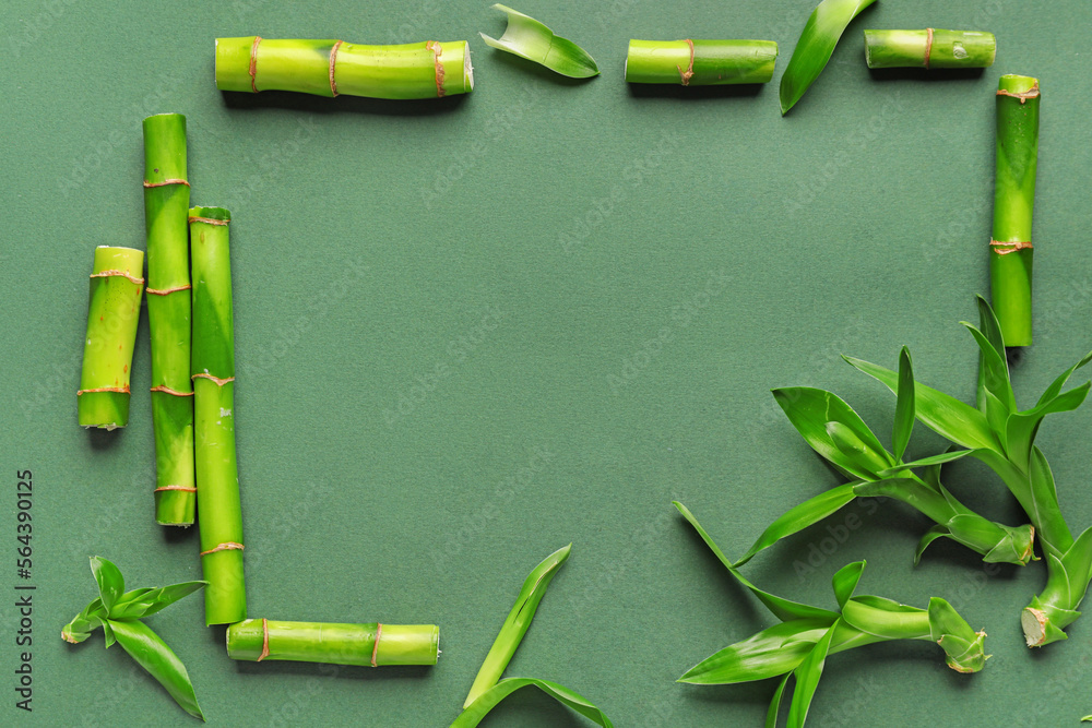 Frame made of fresh bamboo stems on green background