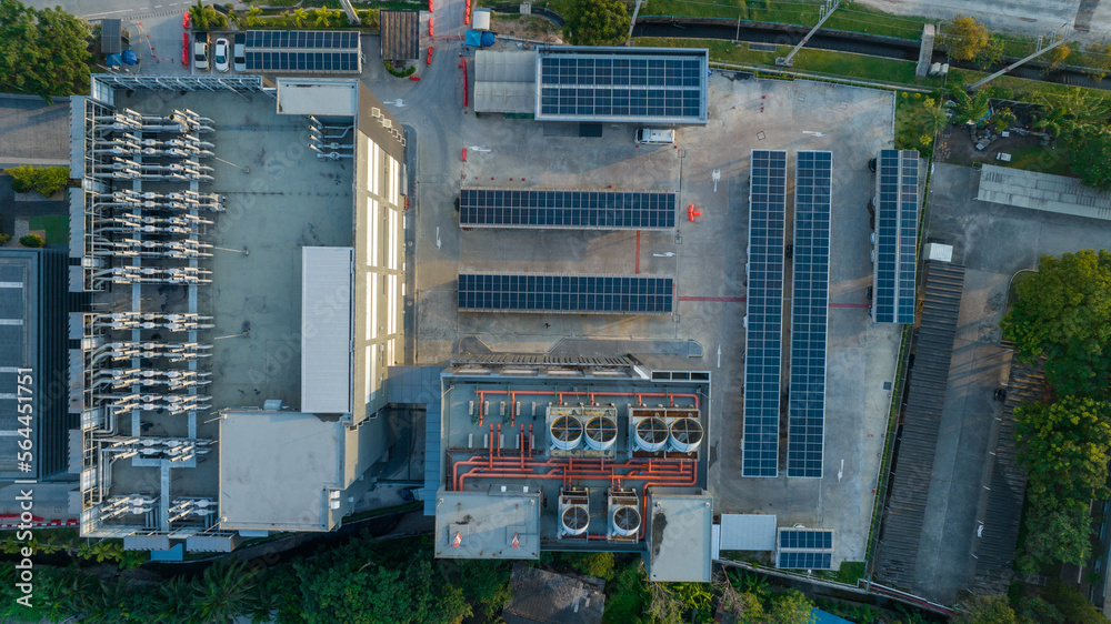 Top view of blue solar photo voltaic panels system on high apartment building roof top on sunny day.