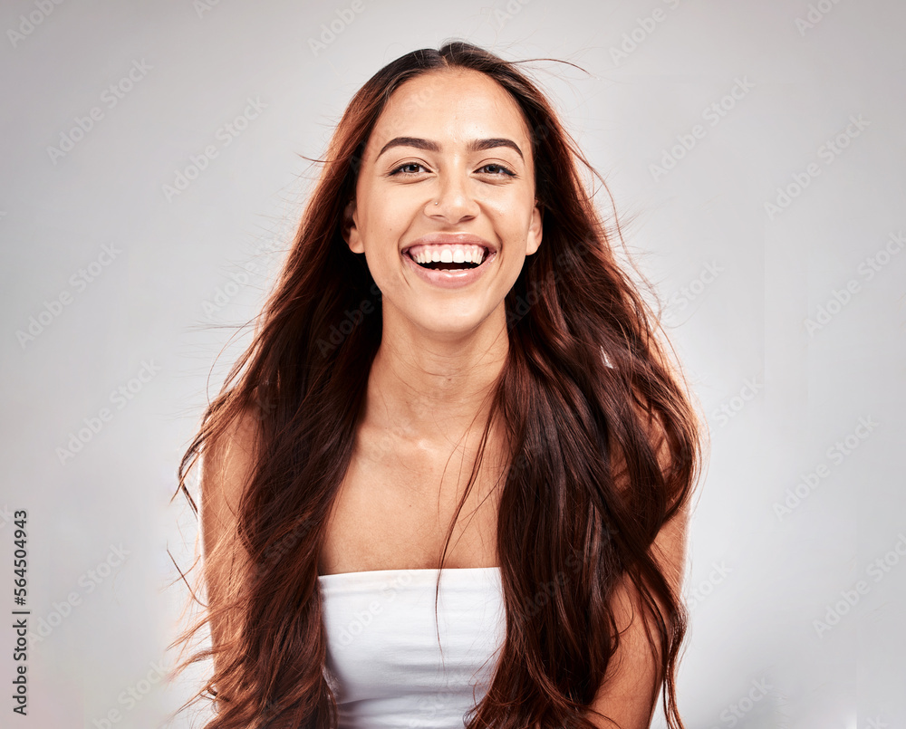 Cosmetics, portrait and woman with hair care, shine and girl with smile on grey studio background. F