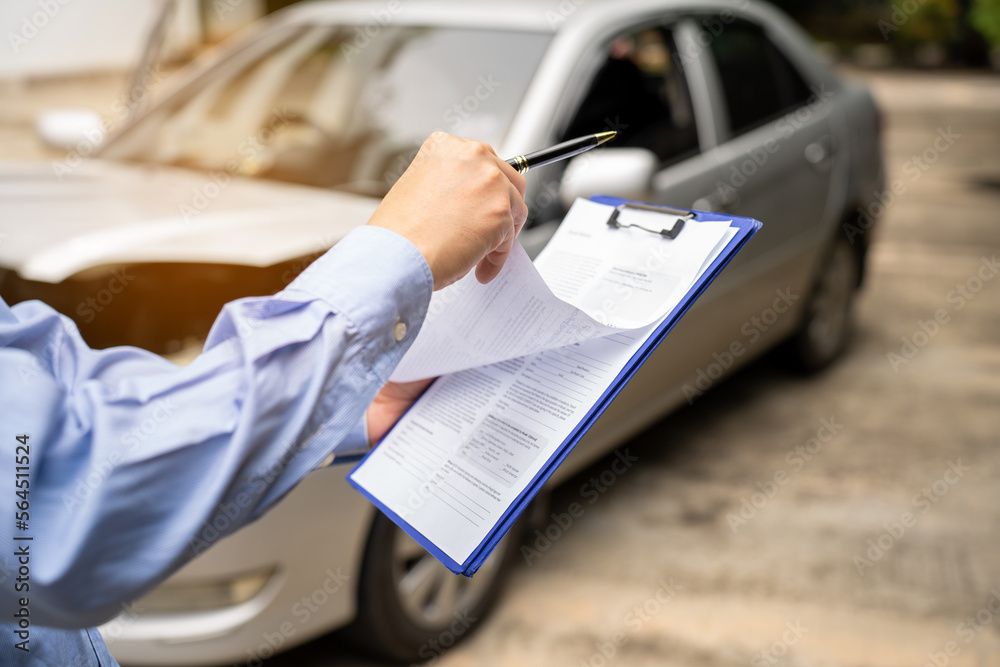 Insurance officer writing Insurance Claim Report on clipboard while insurance. Man and Insurance age