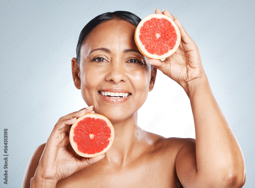 Grapefruit, portrait and vitamin c skincare of happy woman on studio background. Beauty model, face 