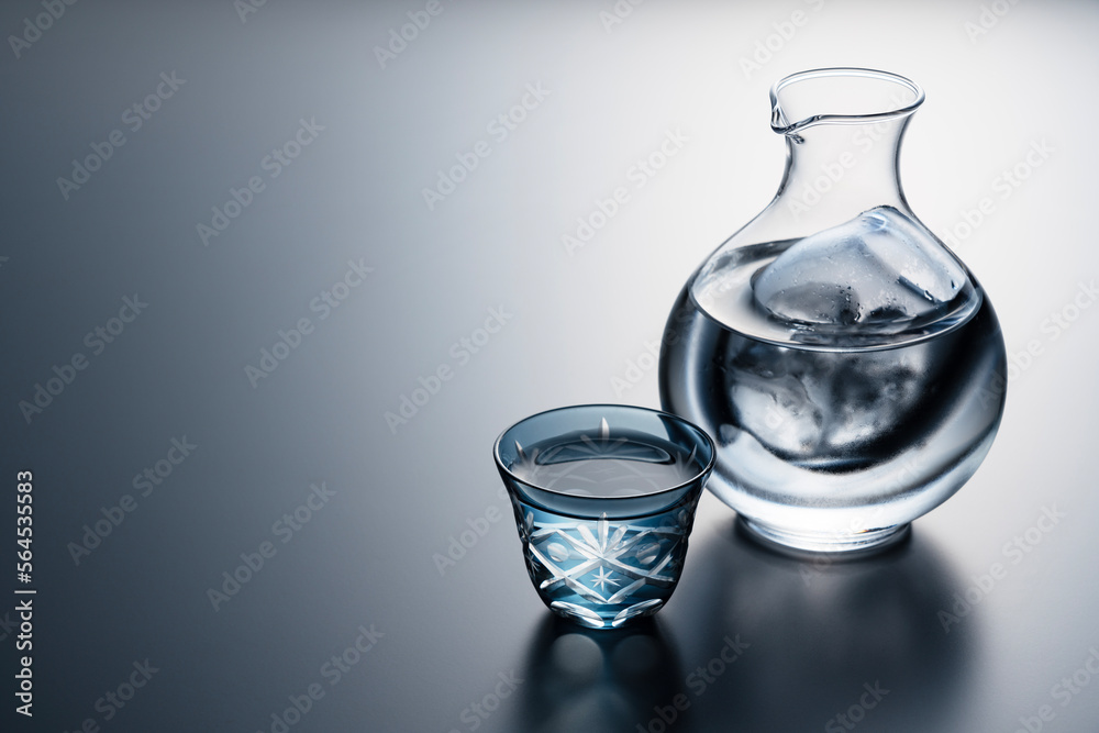 Sake poured into a faceted glass against a black background.