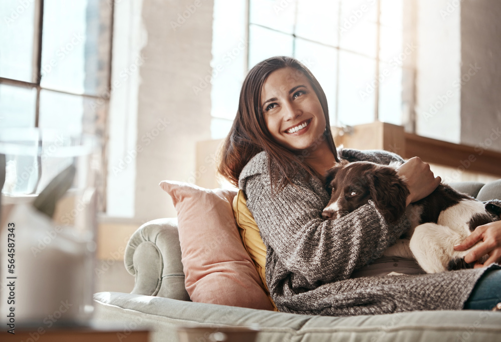 Woman relax on couch with dog, smile and content at home with pet and happy together with peace in l