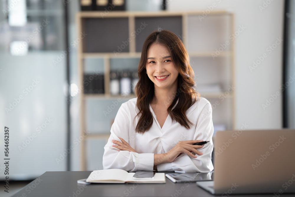 Young beautiful businesswoman working on her project in modern office room.