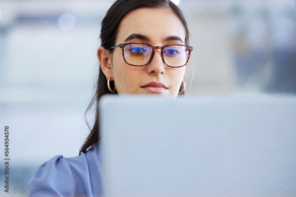 Business woman, glasses and working on laptop in office, agency and startup company. Focus, face and