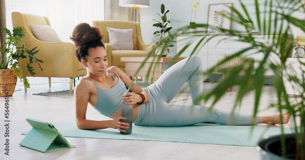 Fitness, relax and woman drinking water in living room with tablet streaming online class for workou