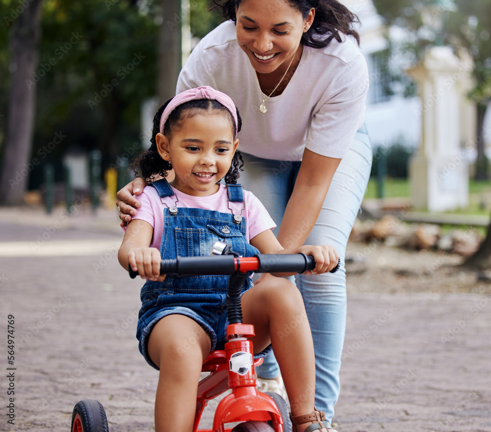 Mother, child and bicycle teaching with training wheels for learning or practice at the park. Happy 