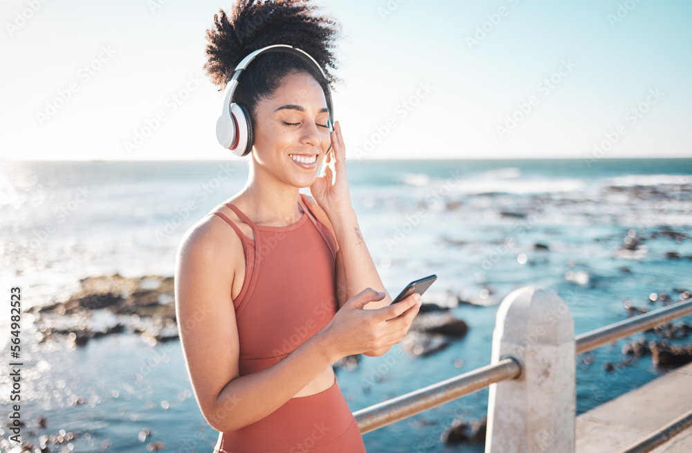 Black woman at beach, headphone and smartphone with fitness, runner listening to music for sports mo