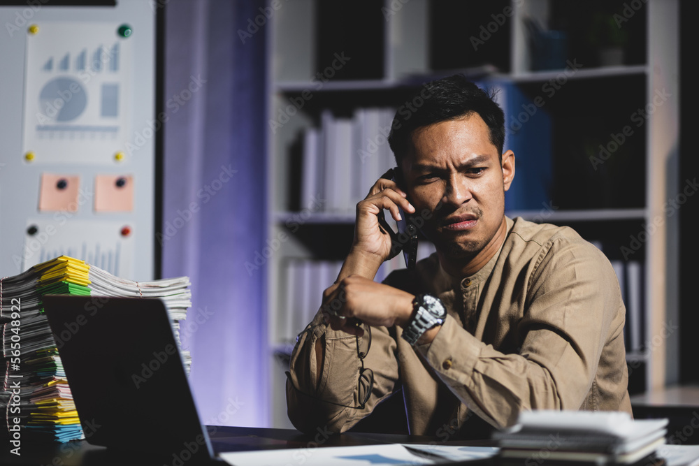 Business people in the night office working overtime are stressed by overwork and worrying about dea