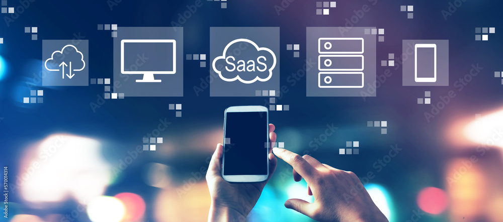 SaaS - software as a service concept with blurred city lights at night