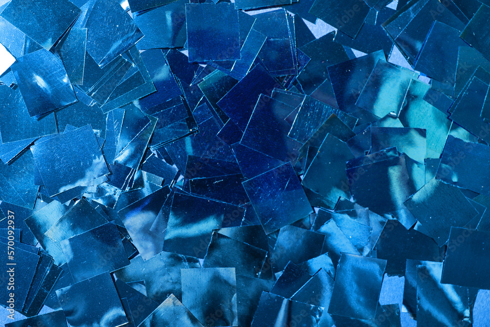 Blue confetti as background, closeup