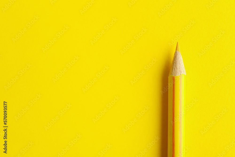 Yellow pencil on color background