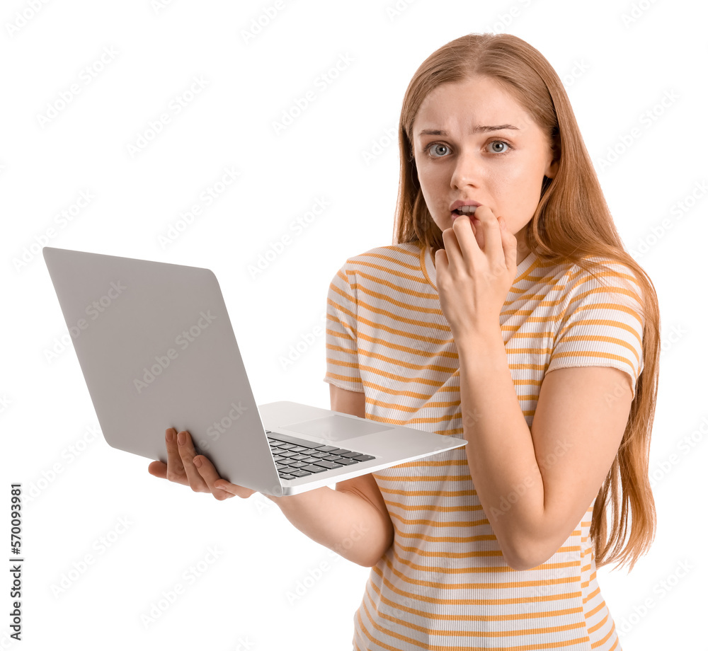 Young woman with laptop biting nails on white background