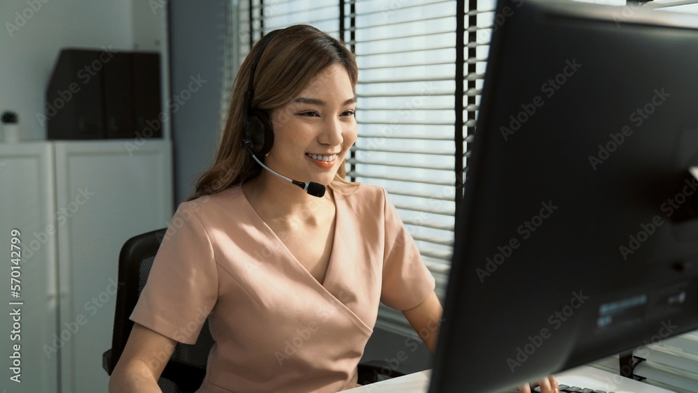 Competent female operator working on computer and while talking with clients. Concept relevant to bo