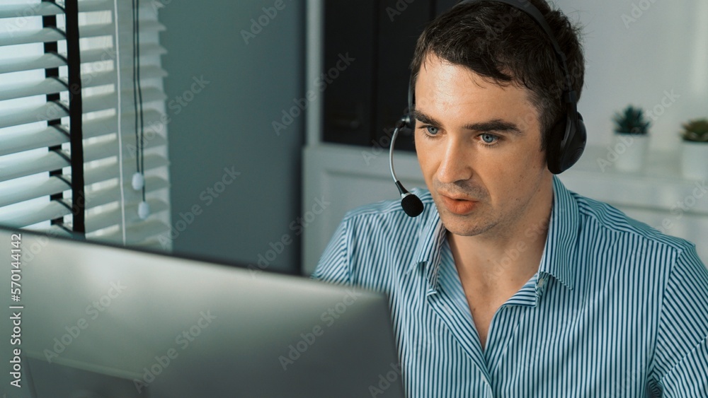 Competent male operator working with customers in the office. Concept of an operator, customer servi