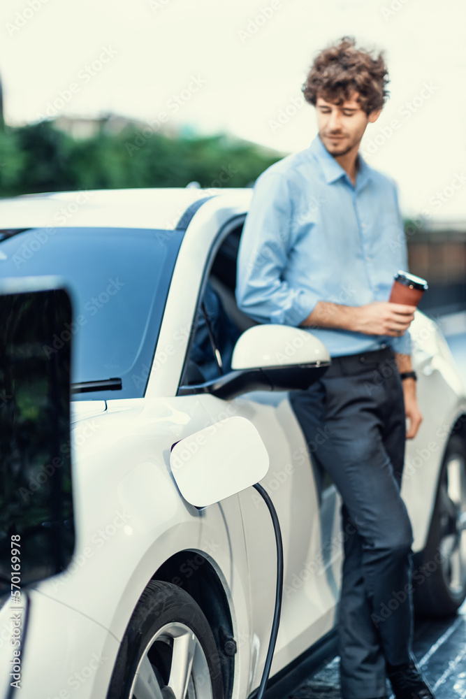 Progressive eco-friendly concept of focus parking EV car at public electric-powered charging station