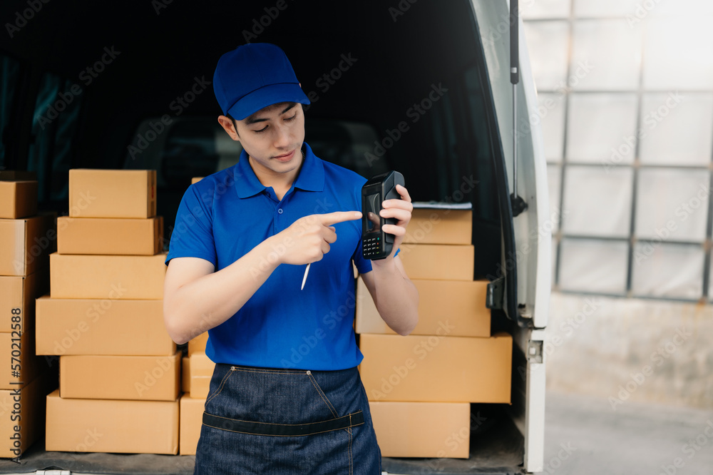 Happy delivery man standing with arms crossed near van outside the warehouse. This is a freight tran