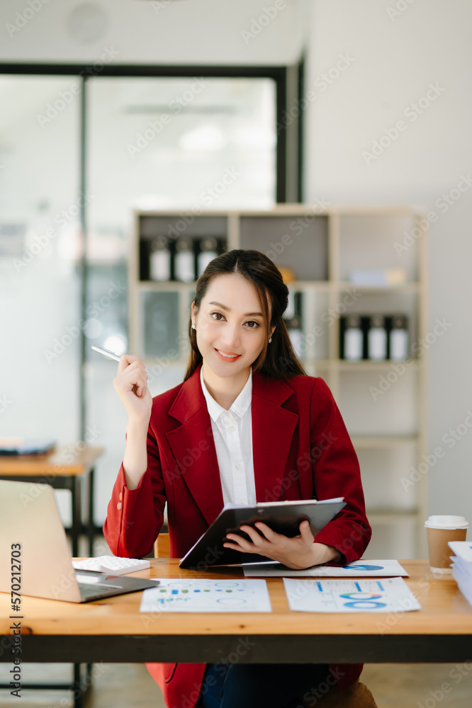 Woman freelancer is working her job on computer tablet and laptop Doing accounting analysis report r