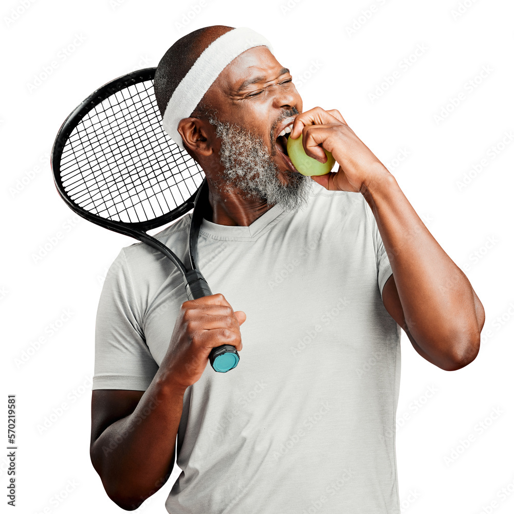 A happy mature african american man standing and biting a green apple with a tennis racquet on his s