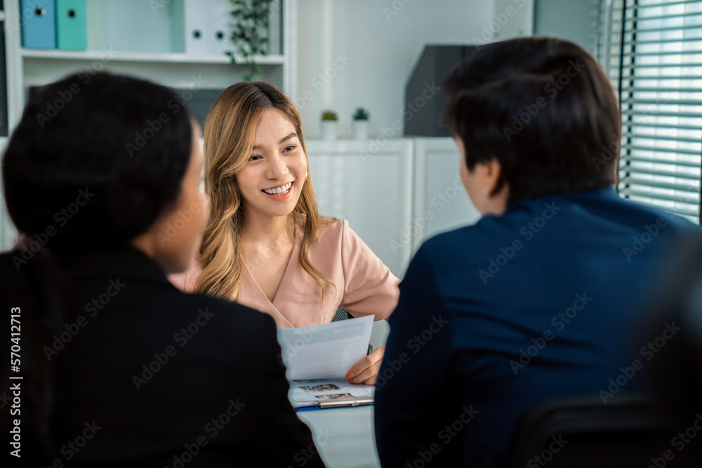 A young female asian candidate tries to impress her interviewer by being competent. International co