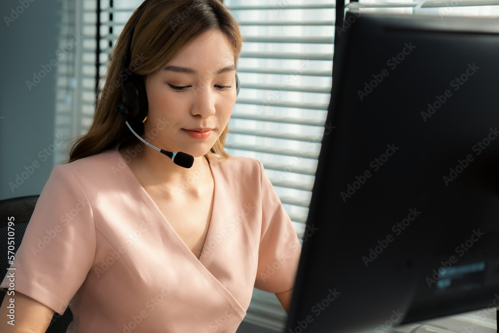 Competent female operator working on computer and while talking with clients. Concept relevant to bo