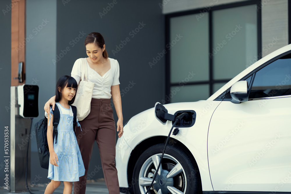 Progressive lifestyle of mother and daughter who have just returned from school in an electric vehic